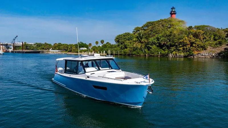 Slide: The Image of 2024 MJM 4 boat cruising near a lighthouse on a sunny day. - 18