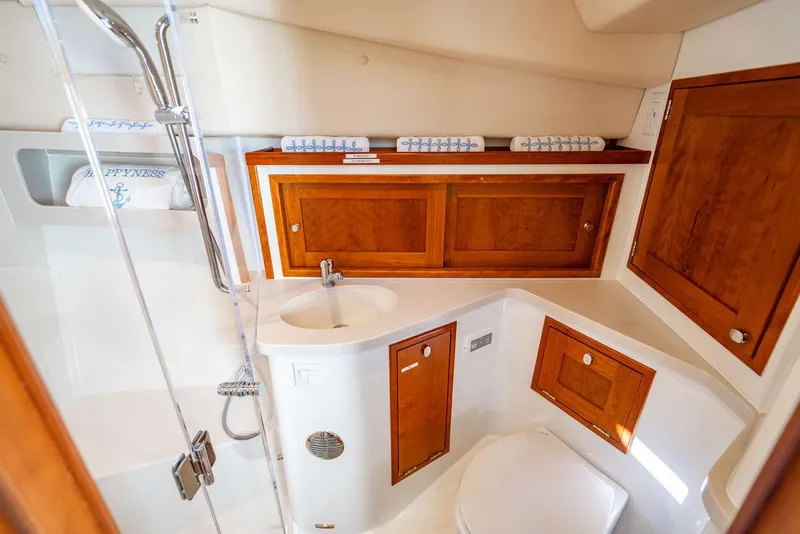 Slide: The Image of 2024 MJM 4 yacht bathroom with wooden cabinets, sink, and shower. - 31