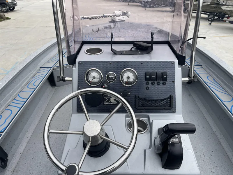 Slide: The Image of 2020 Xpress X23B boat dashboard with steering wheel, gauges, and controls. - 10