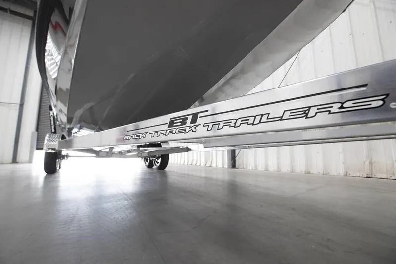 Slide: The Image of Trailer under Xpress X23B boat, 2020 model, in a warehouse setting. - 18