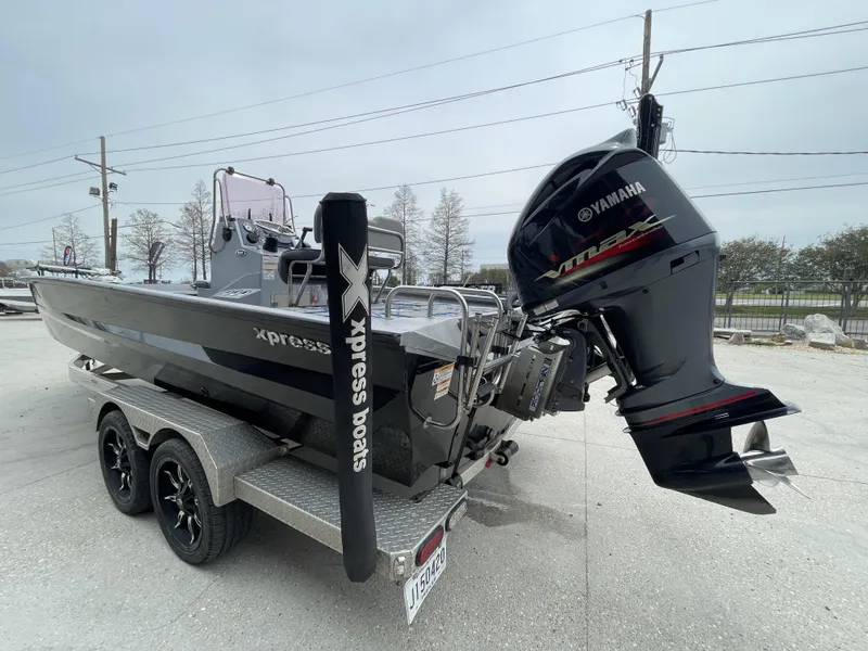 Slide: The Image of 2020 Xpress X23B boat with Yamaha engine on a trailer. - 2