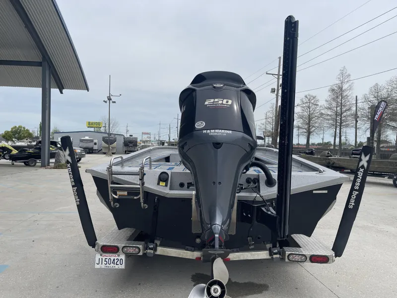 Slide: The Image of 2020 Xpress X23B boat with powerful 250 horsepower engine, parked at a dealership. - 3