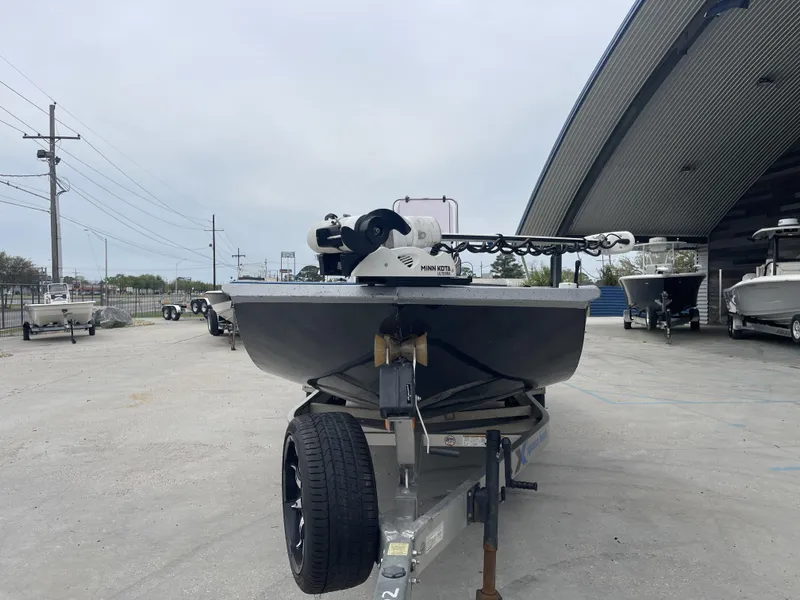 Slide: The Image of 2020 Xpress X23B boat on trailer, parked outdoors near a metal building. - 4