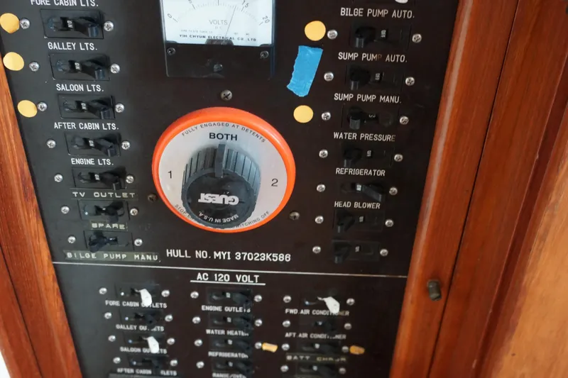 Slide: The Image of Control panel of a 1986 President 37 Sundeck boat with various switches and dials. - 10