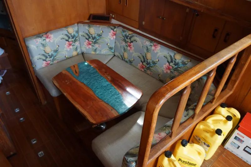 Slide: The Image of 1986 President 37 Sundeck interior with floral seating and unique wooden table design. - 4
