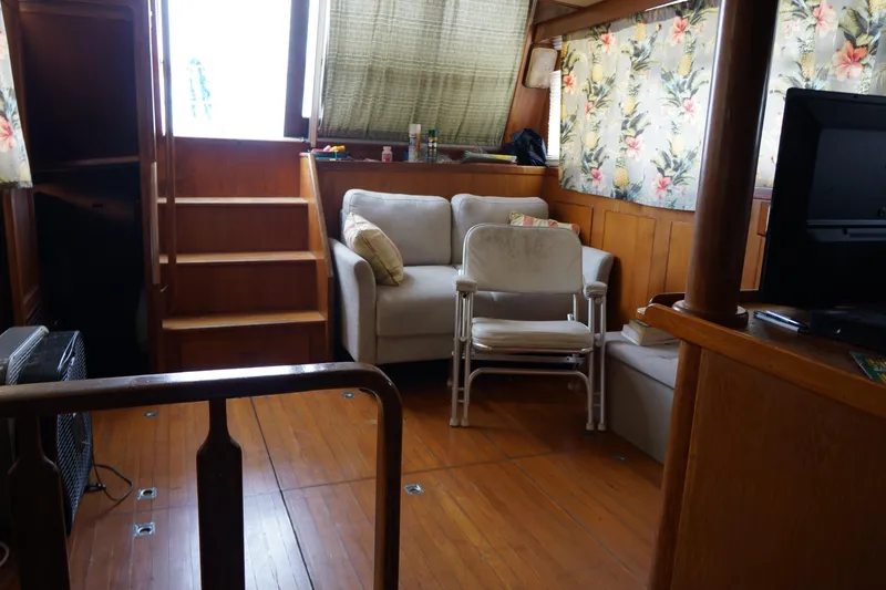 Slide: The Image of Interior of 1986 President 37 Sundeck yacht with cozy seating and floral decor. - 6
