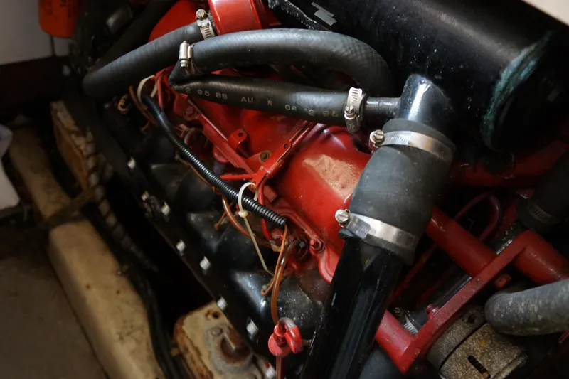 Slide: The Image of Engine components of a 1986 President 37 Sundeck boat, featuring hoses and wiring. - 8