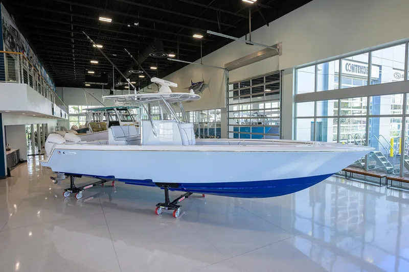 Slide: The Image of 2025 Contender 32 ST boat displayed indoors, featuring sleek design and modern amenities. - 1