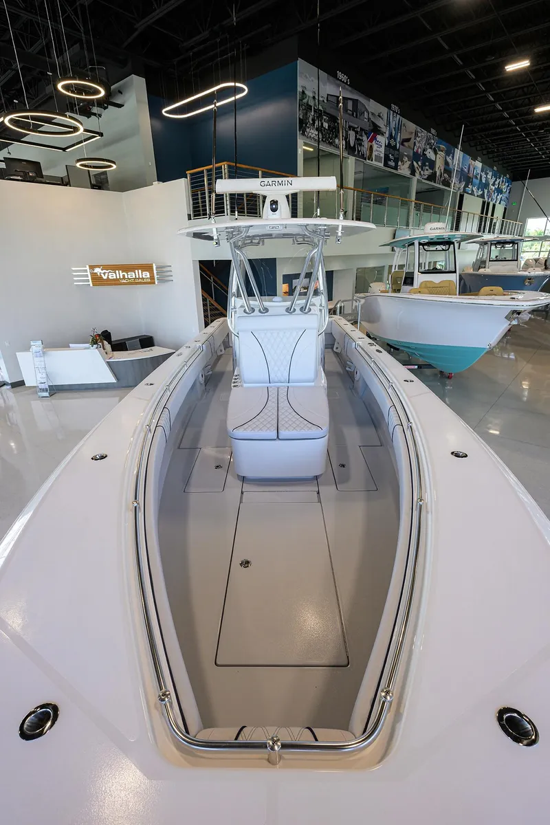 Slide: The Image of 2025 Contender 32 ST boat in showroom, showcasing sleek design and modern features. - 10