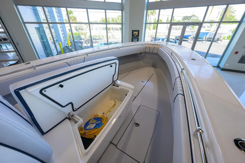 Slide: The Image of 2025 Contender 32 ST boat interior with open storage compartment in showroom. - 13