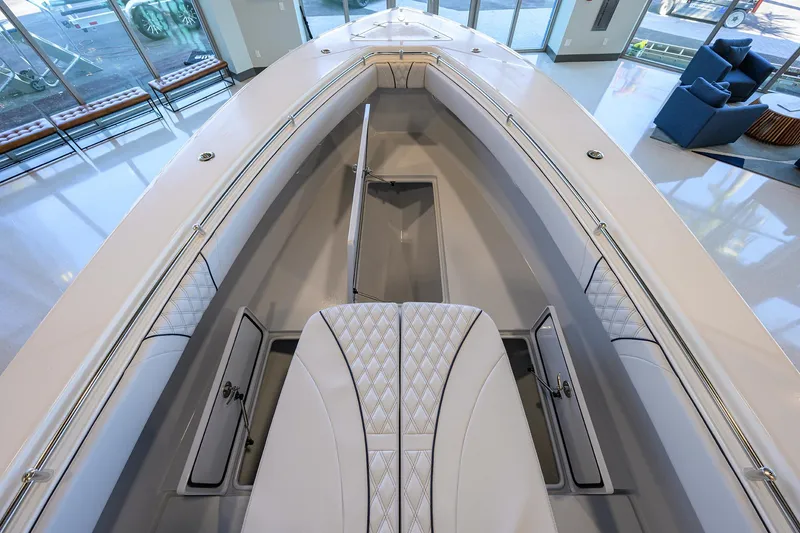 Slide: The Image of 2025 Contender 32 ST boat interior with sleek seating and storage compartments. - 14