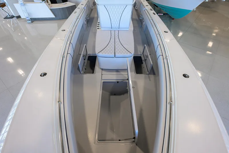 Slide: The Image of 2025 Contender 32 ST boat interior with sleek seating and storage compartments. - 15