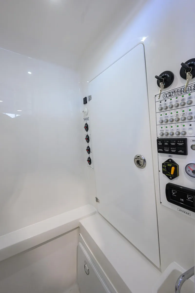 Slide: The Image of 2025 Contender 32 ST boat control panel with switches and gauges. - 19