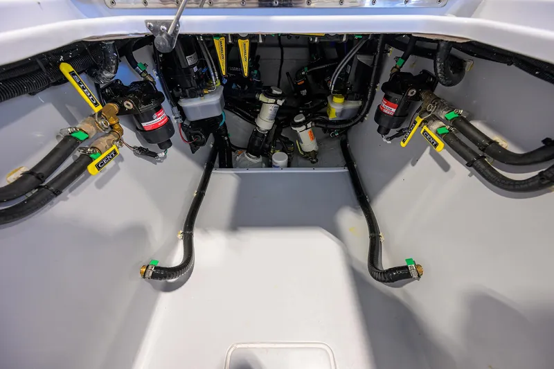 Slide: The Image of 2025 Contender 32 ST boat engine compartment with visible hoses and components. - 20