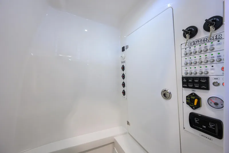 Slide: The Image of 2025 Contender 32 ST boat interior with control panel and storage compartment. - 21