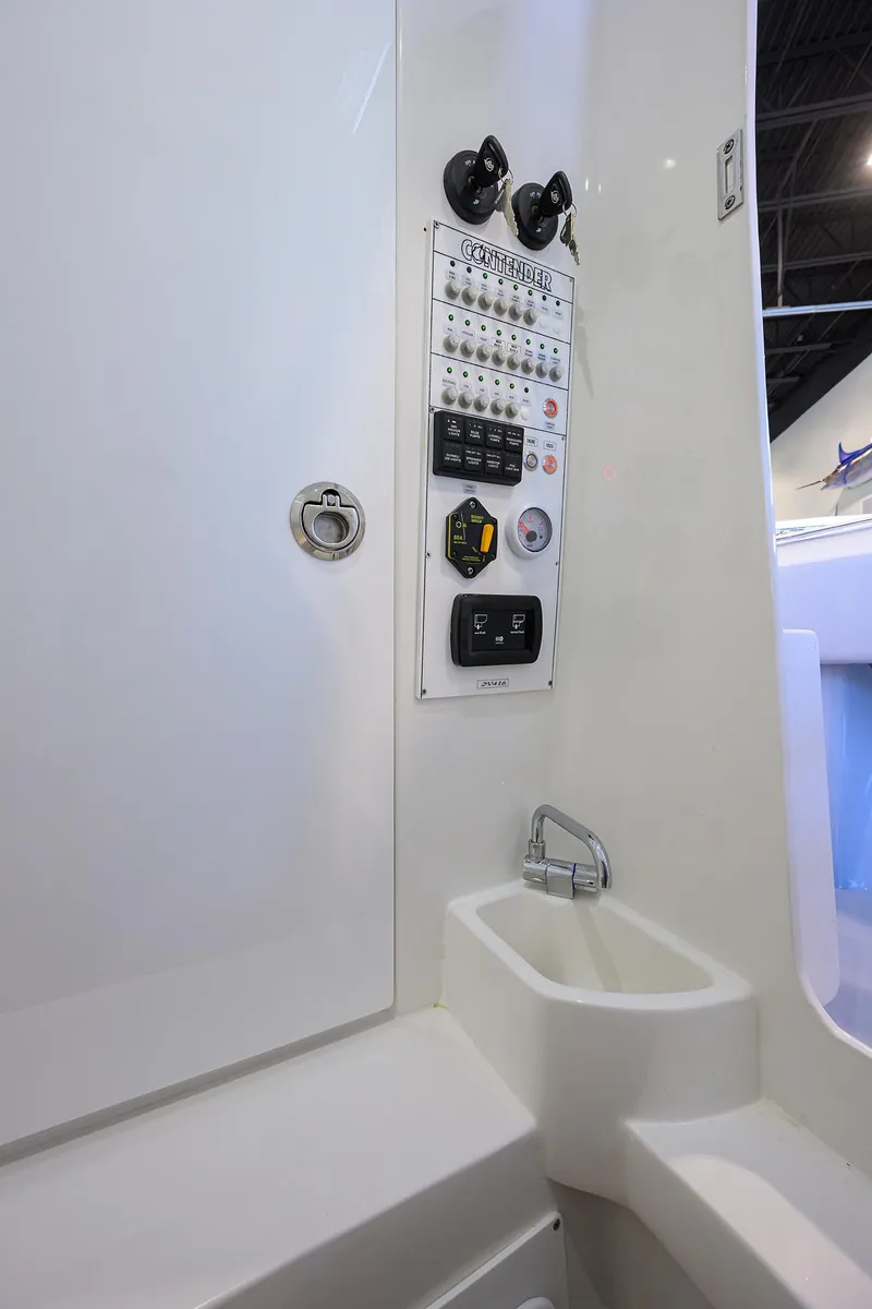 Slide: The Image of Control panel and sink inside 2025 Contender 32 ST boat. - 24