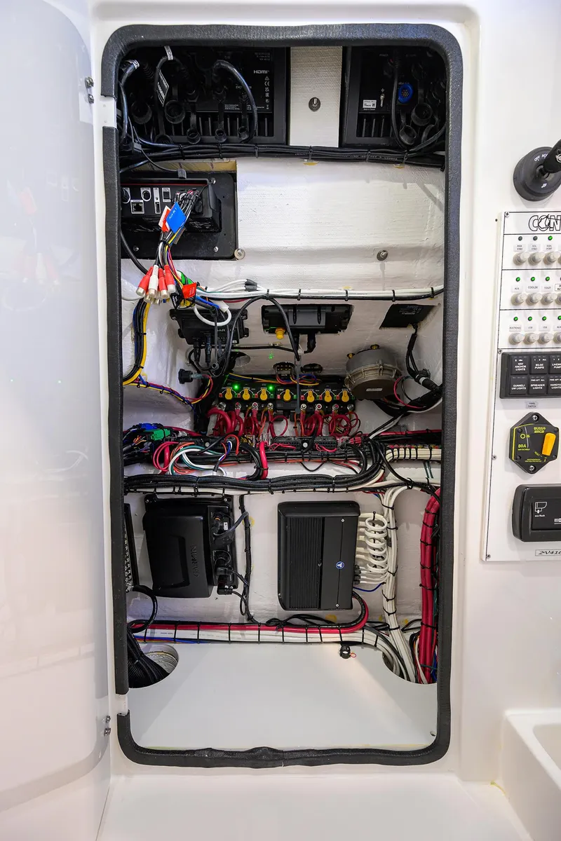 Slide: The Image of Electrical panel inside 2025 Contender 32 ST boat, showcasing wiring and components. - 25