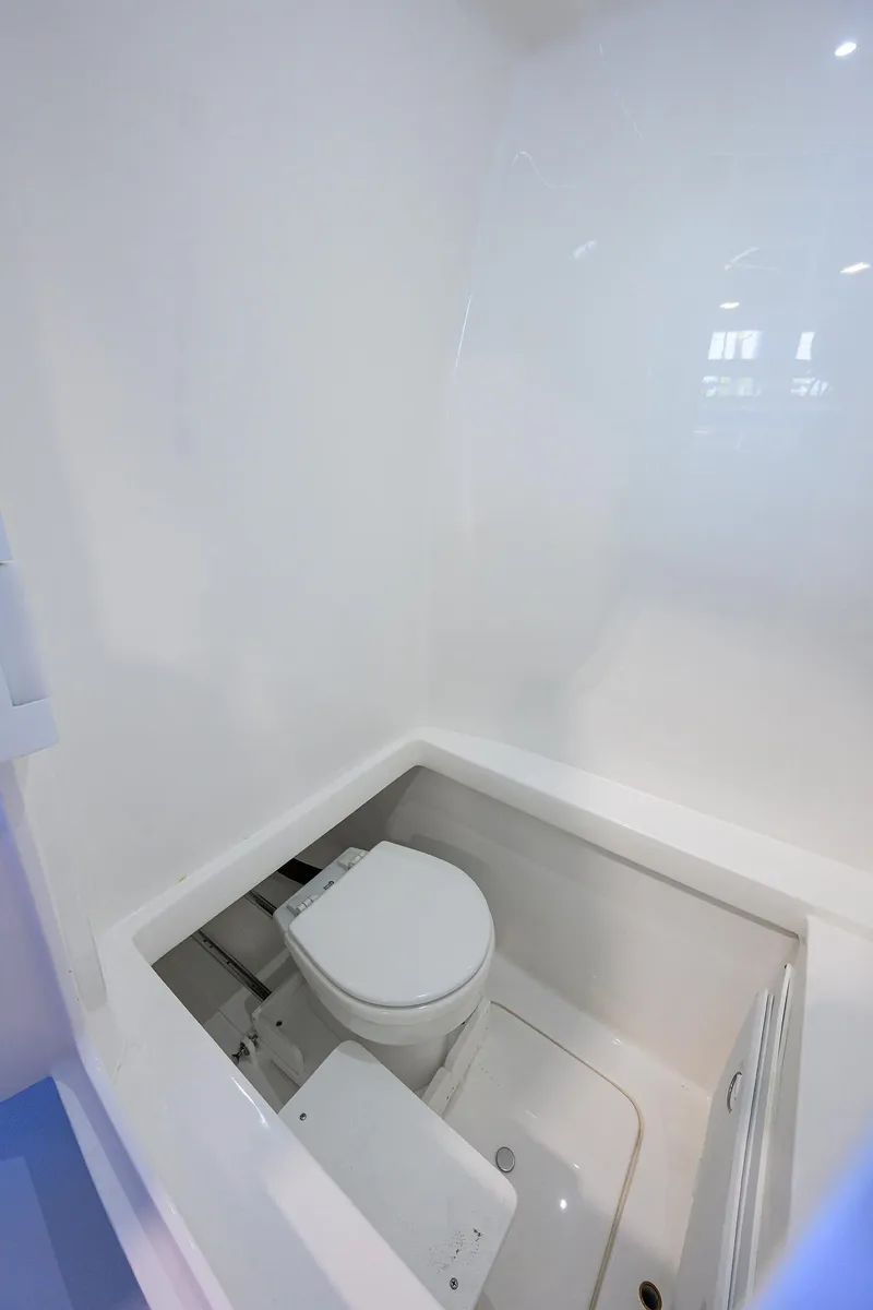 Slide: The Image of 2025 Contender 32 ST boat interior with compact marine toilet. - 26