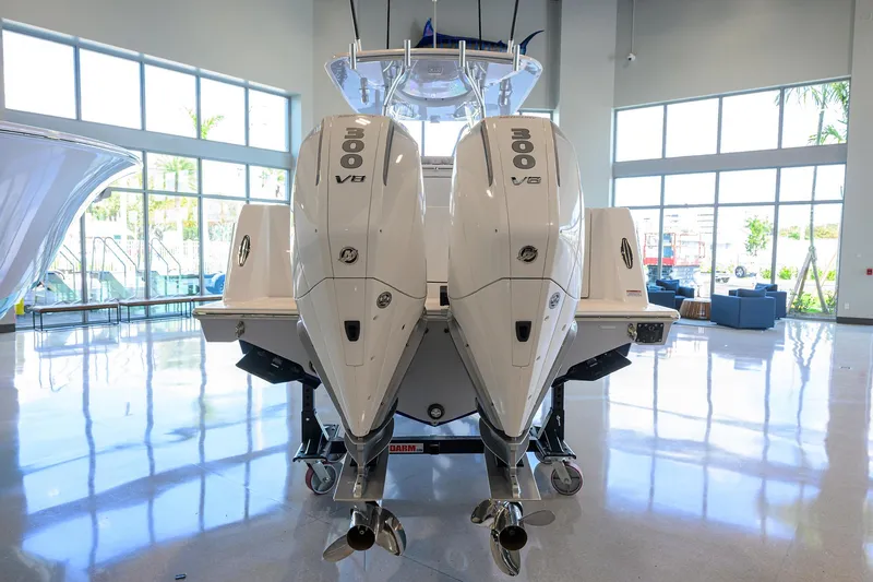 Slide: The Image of 2025 Contender 32 ST boat with dual 300 V8 engines in a showroom. - 27