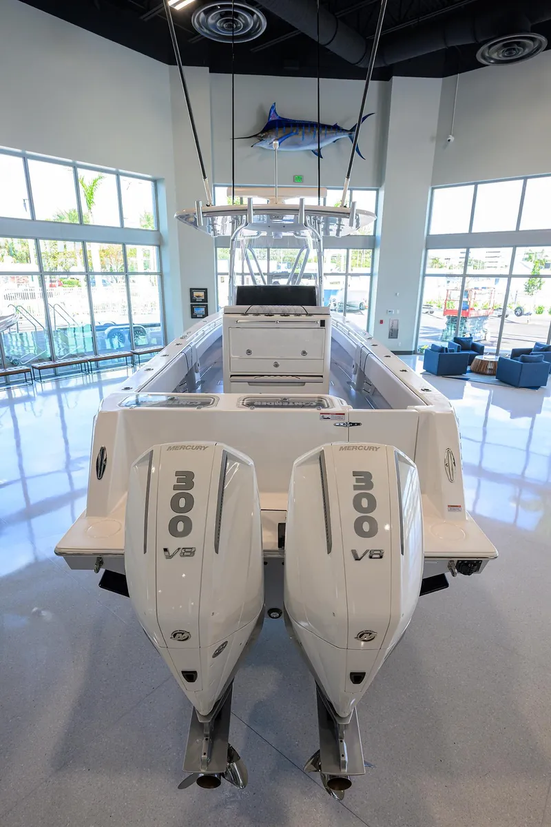 Slide: The Image of 2025 Contender 32 ST boat with dual 300 V8 engines in showroom. - 28
