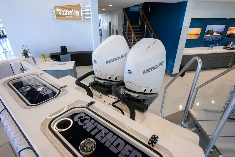 Slide: The Image of 2025 Contender 32 ST boat with dual Mercury engines in showroom. - 31