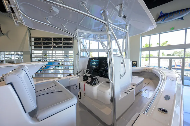 Slide: The Image of 2025 Contender 32 ST boat interior with modern helm and seating in showroom. - 7