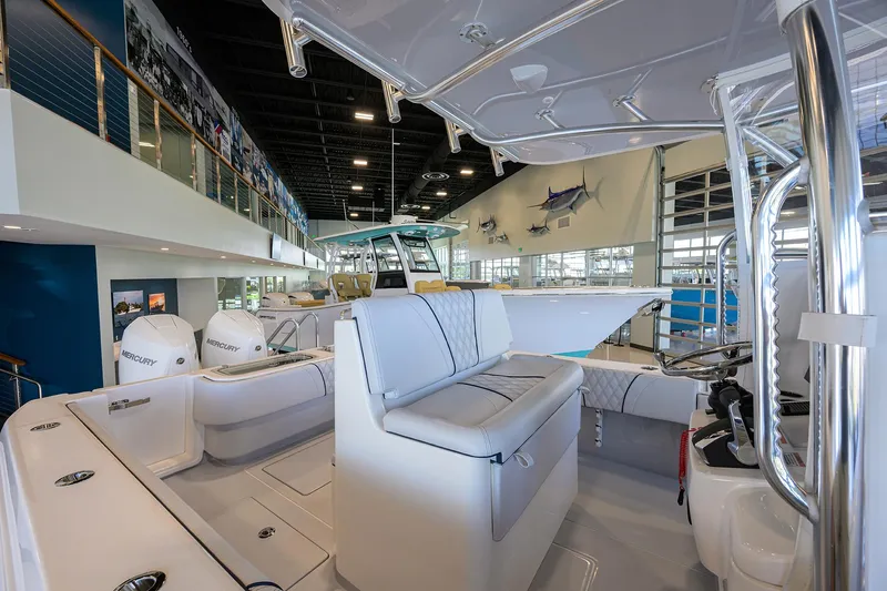 Slide: The Image of 2025 Contender 32 ST boat interior with seating and modern design in showroom. - 8