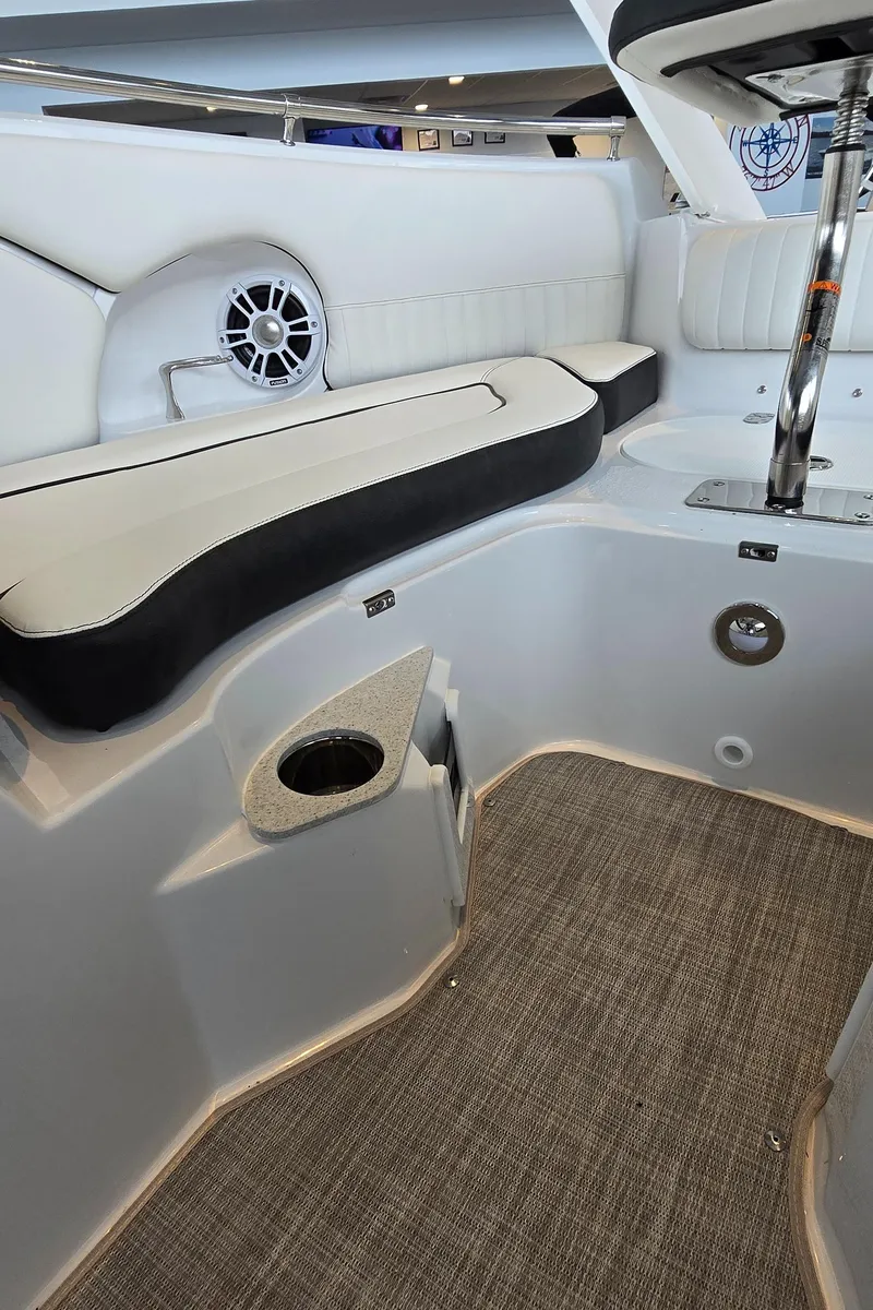 Slide: The Image of 2025 Stingray 211DC boat interior with cushioned seating and modern design. - 10
