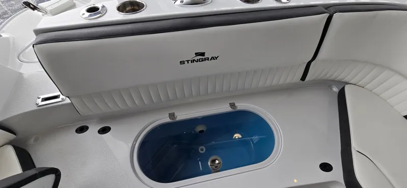 Slide: The Image of 2025 Stingray 211DC boat interior with seating and storage compartment. - 4