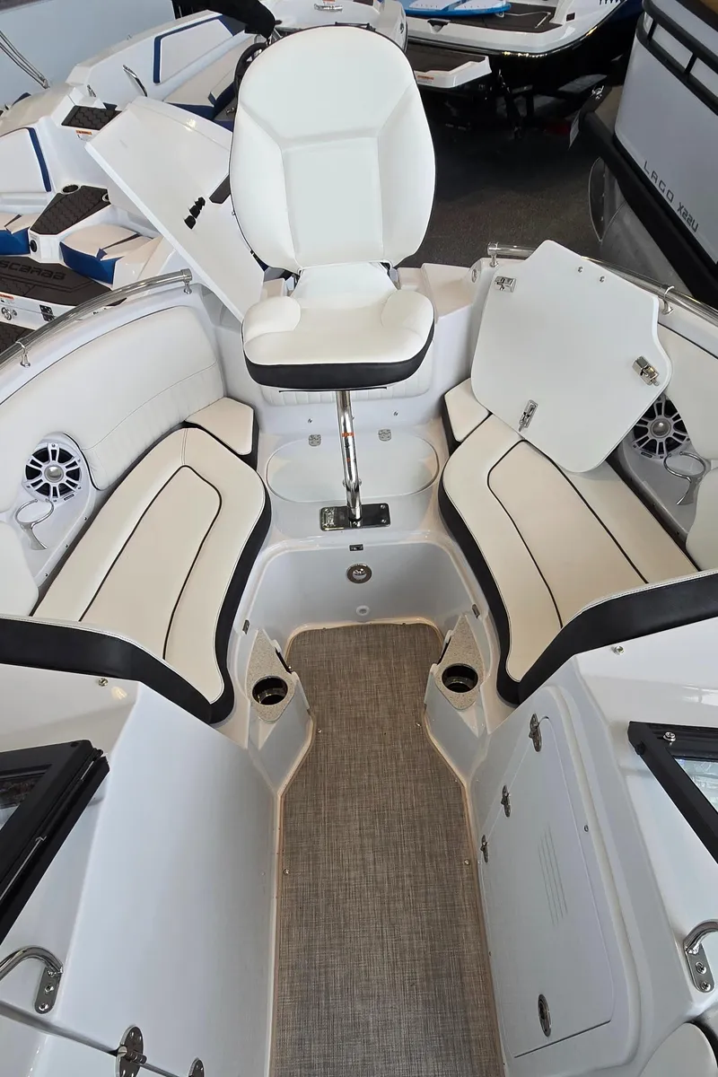Slide: The Image of 2025 Stingray 211DC boat interior with white seating and modern design. - 9