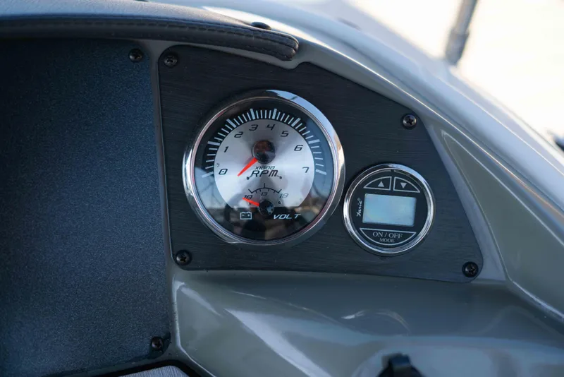 Slide: The Image of Dashboard of 2019 Stingray 212 SC boat with RPM and volt gauges. - 23