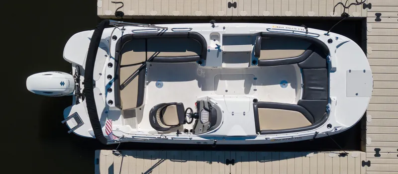 Slide: The Image of 2019 Stingray 212 SC boat docked, aerial view, white and black design. - 5