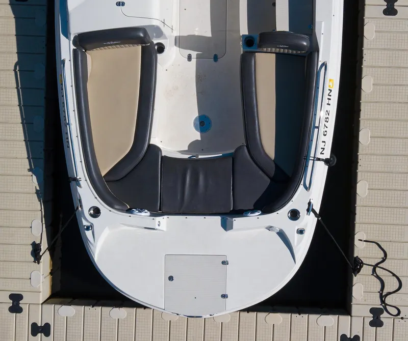 Slide: The Image of Overhead view of a 2019 Stingray 212 SC boat docked, showcasing seating and deck layout. - 7