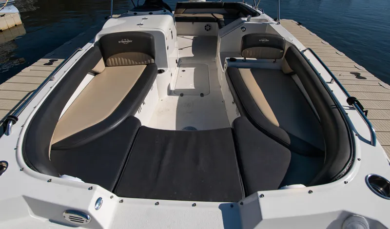 Slide: The Image of 2019 Stingray 212 SC boat interior with spacious seating and sleek design. - 8