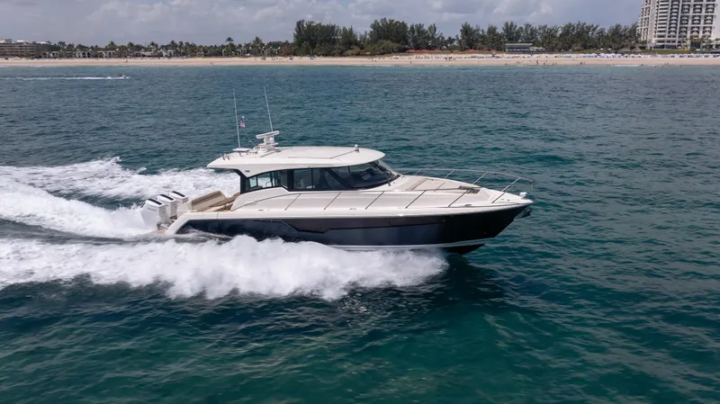 Slide: The Image of 2024 Tiara Yachts 48 LE cruising on open water, showcasing sleek design and powerful performance. - 10