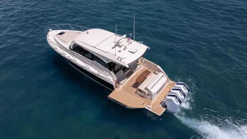 Slide: The Image of 2024 Tiara Yachts 48 LE cruising on open water, showcasing sleek design and powerful engines. - 15