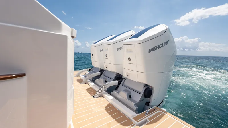 Slide: The Image of 2024 Tiara Yachts 48 LE with dual Mercury outboard engines on open sea. - 23