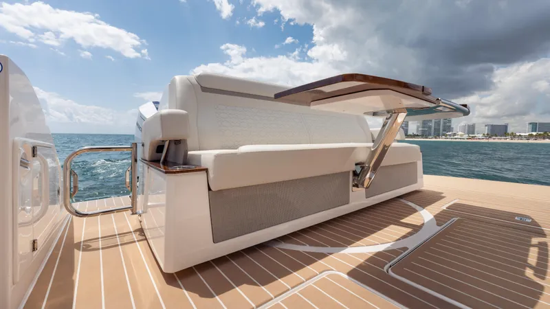 Slide: The Image of 2024 Tiara Yachts 48 LE luxury yacht deck with seating, ocean view, and city skyline. - 27