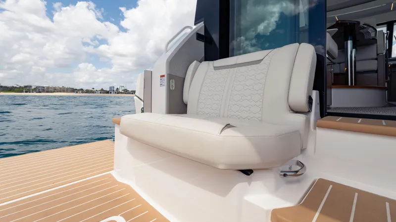 Slide: The Image of 2024 Tiara Yachts 48 LE with elegant seating, docked on calm waters under a cloudy sky. - 29