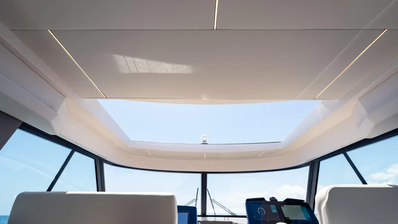 Slide: The Image of 2024 Tiara Yachts 48 LE interior with panoramic sunroof and modern dashboard. - 34