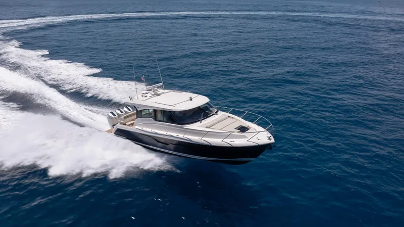 Slide: The Image of 2024 Tiara Yachts 48 LE cruising swiftly on open ocean waters. - 4