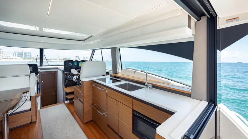 Slide: The Image of 2024 Tiara Yachts 48 LE interior with modern kitchen and ocean view. - 41