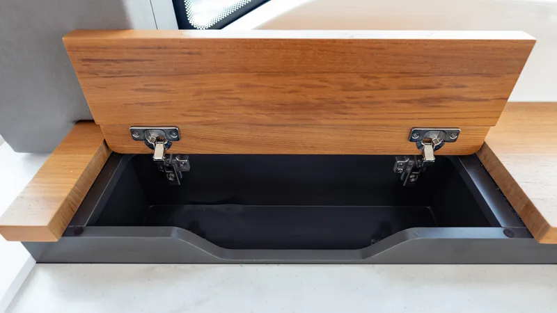 Slide: The Image of Open wooden storage compartment on 2024 Tiara Yachts 48 LE. - 43