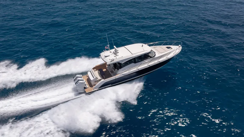 Slide: The Image of 2024 Tiara Yachts 48 LE cruising swiftly on open blue ocean waters. - 5