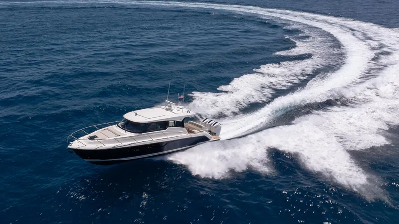 Slide: The Image of 2024 Tiara Yachts 48 LE cruising on open ocean, showcasing sleek design and powerful performance. - 6
