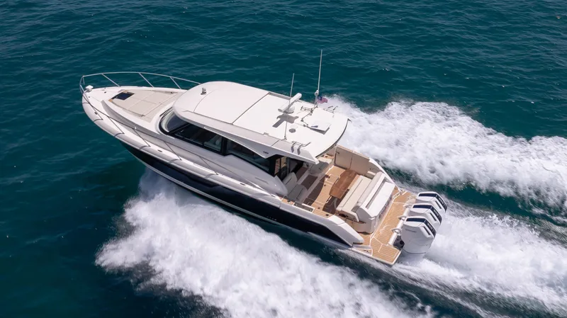 Slide: The Image of 2024 Tiara Yachts 48 LE cruising swiftly on open blue waters. - 8