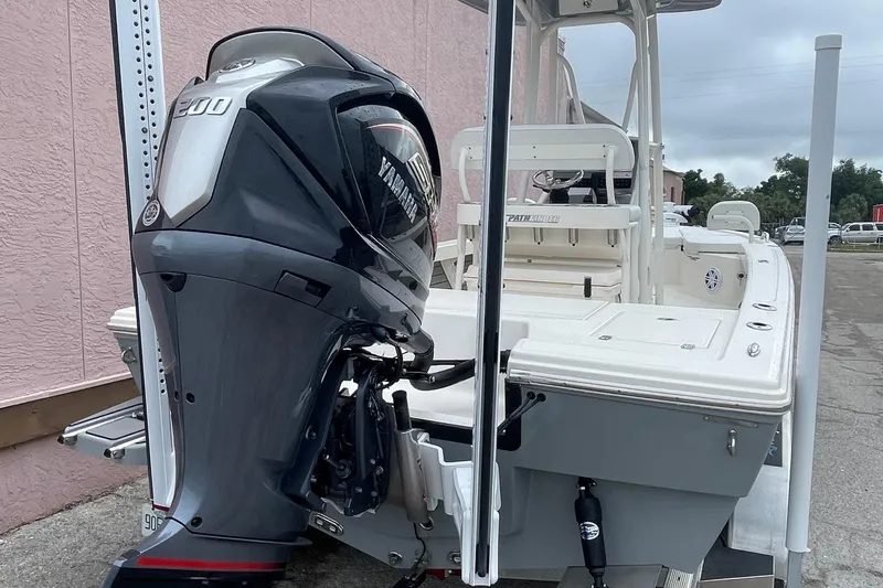 Slide: The Image of 2024 Pathfinder 2200 TRS boat with Yamaha outboard motor, docked outdoors. - 10
