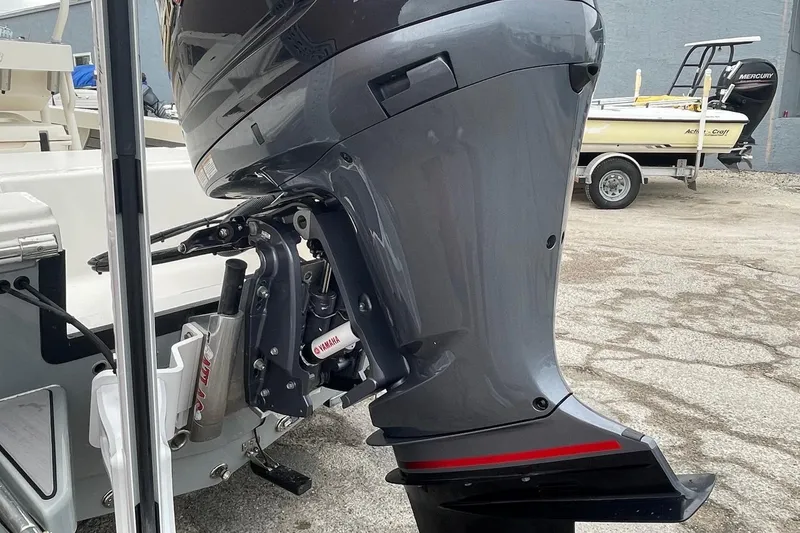 Slide: The Image of 2024 Pathfinder 2200 TRS boat with Yamaha outboard motor, parked on concrete surface. - 11