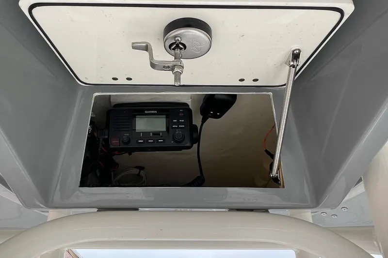 Slide: The Image of 2024 Pathfinder 2200 TRS boat console with Garmin radio and secure storage compartment. - 12