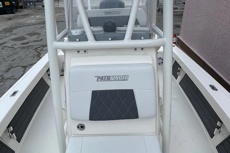 Slide: The Image of 2024 Pathfinder 2200 TRS boat interior with white seating and console. - 14